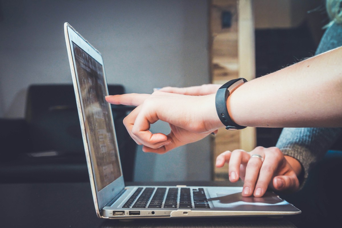 Collaborative planning with a laptop and notes, supporting a structured branding process