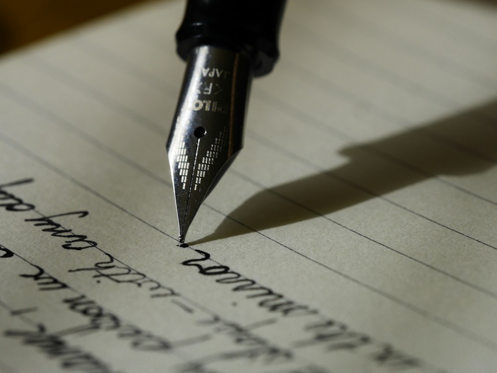 Writing and sketching in a notebook during the development of a brand idea